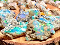 a pile of opal rocks on a wooden table