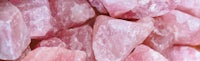 a pile of pink crystals on a table