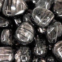 a pile of black and silver stones